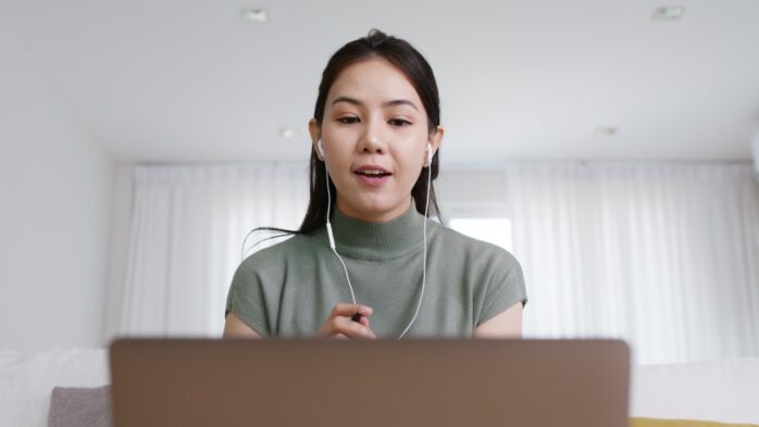 Remote Filipino virtual assistant working from home on a laptop during an online meeting